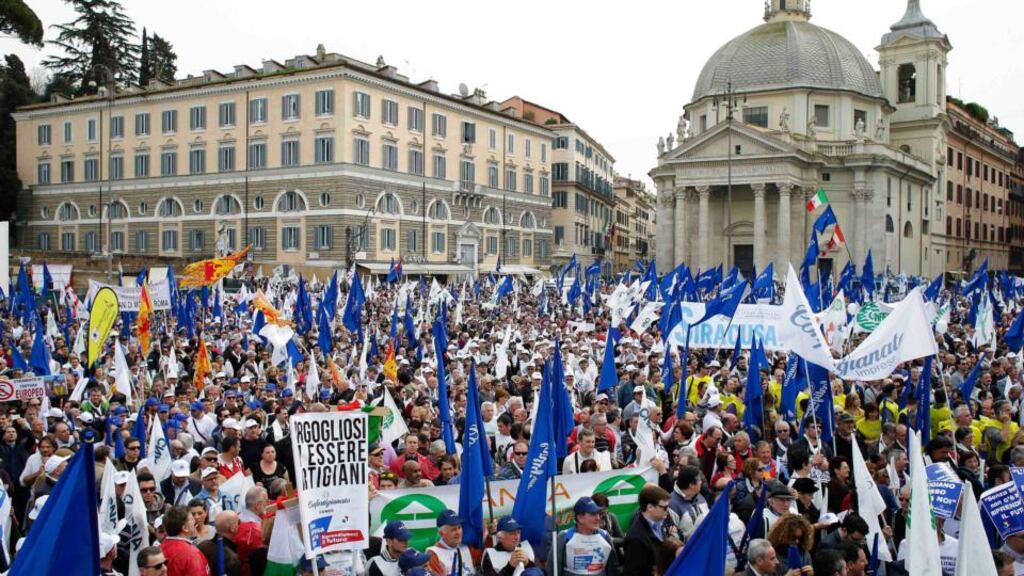 People take part in a rally calling for lower taxes and better protection for small enterprises in downtown Rome