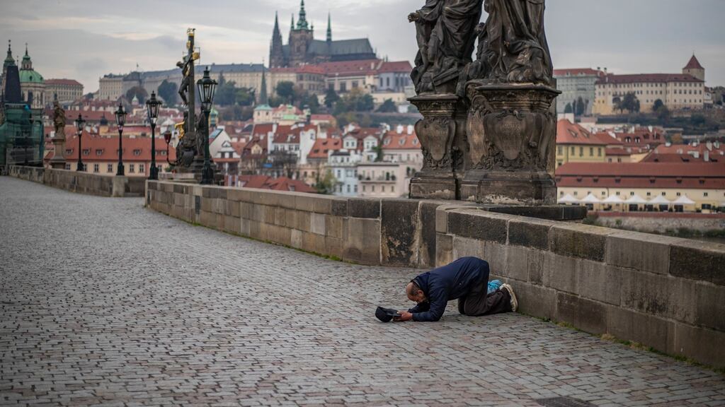 A man begging on an empty Charles Bridge in Prague. The Czech Republic has the worst infection rate in Europe. Photograph: EPA/Martin Divisek