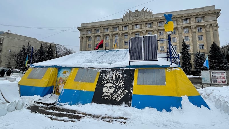 A tent on Freedom Square in Kharkiv that is maintained by volunteers in memory of Ukraine’s 2014 revolution. Behind it is the Kharkiv regional administration building, which during clashes in 2014 was briefly seized by pro-Moscow demonstrators. Photograph: Daniel McLaughlin