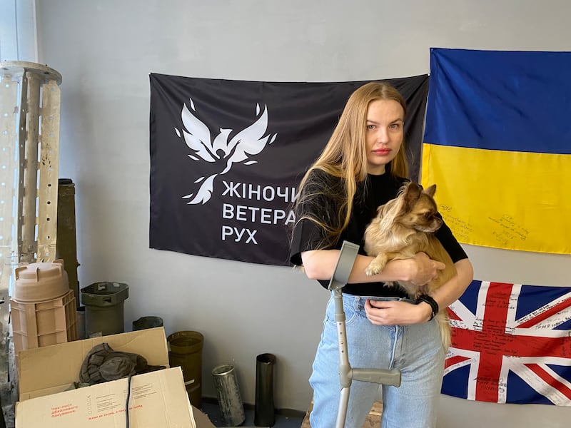 “Alaska”, a medic with a combat unit in eastern Ukraine, was wounded by a Russian drone last January. She is shown here with a display of captured Russian equipment in the office of the women’s veterans’ group Veteranka. (Photograph: Lara Marlowe)