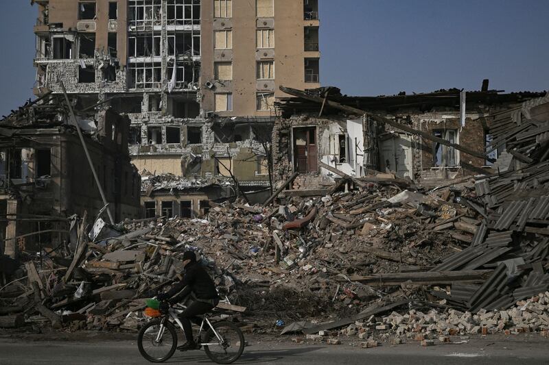 A cyclist rides past by houses destroyed by shelling in Kharkiv on Friday. Photograph: Aris Messinis/AFP via Getty