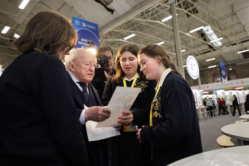 President Michael D Higgins, with Abigail O’Brien Murray, Olivia O’Shea and Erica O’Brien Murray from Loreto Secondary School, Dublin, whose project Can We Save the Common Ash? is at the BT Young Scientist & Technology Exhibition. Photograph: Dara Mac Dónaill