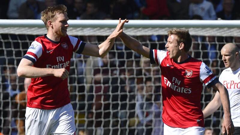 Arsenal's Per Mertesacker (left) celebrates with team mate Nacho Monreal after scoring against Fulham. Photograph: Toby Melville/Reuters