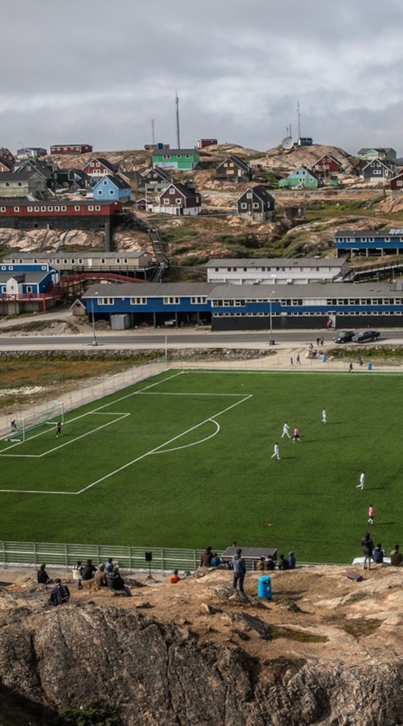 A view of the soccer stadium, an artificial pitch surrounded by a metal fence, in Sisimiut, where Greenland crowns its national soccer champion in the shortest season on earth. Photograph: Kieran Dodds/New York Times