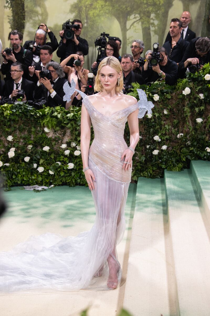Elle Fanning in a sheer sculptural gown with floral shoulder accents by Balmain. Photograph: Lexie Moreland/Getty Images