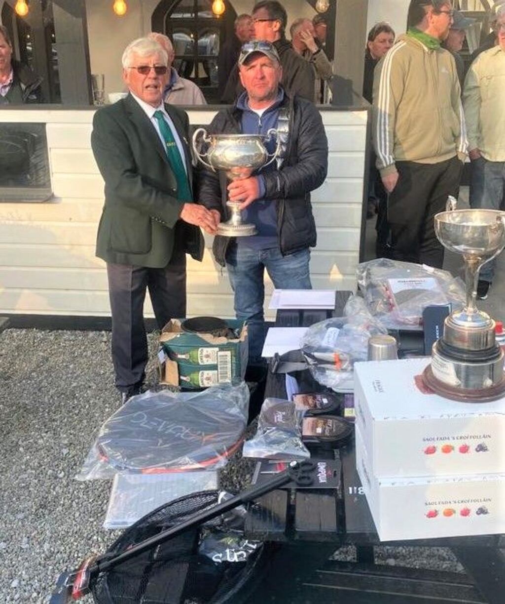 Clare angler, Seamus O'Loughlin (right), receiving the Munster Lake Perpetual Cup from council president, Gerry Kenny