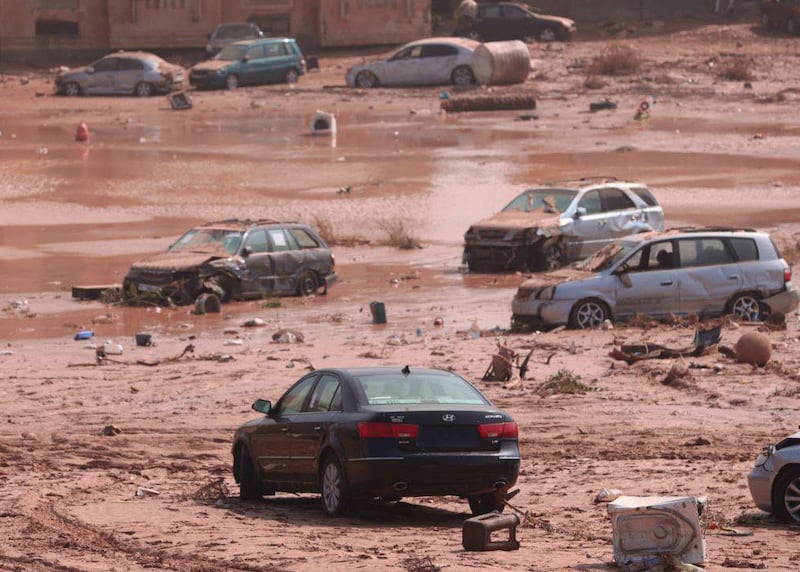 Wrecked cars sit in the receding waters and mud following the flooding in Derna. Photograph: Handout/Anadolu Agency via Getty