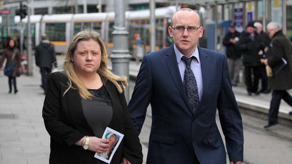 Maree Butler and Eoin Byrne with a photograph of their baby Darragh as they arrive at Dublin Coroners Court for an inquest into his death in 2013. Photo: Gareth Chaney/Collins.
