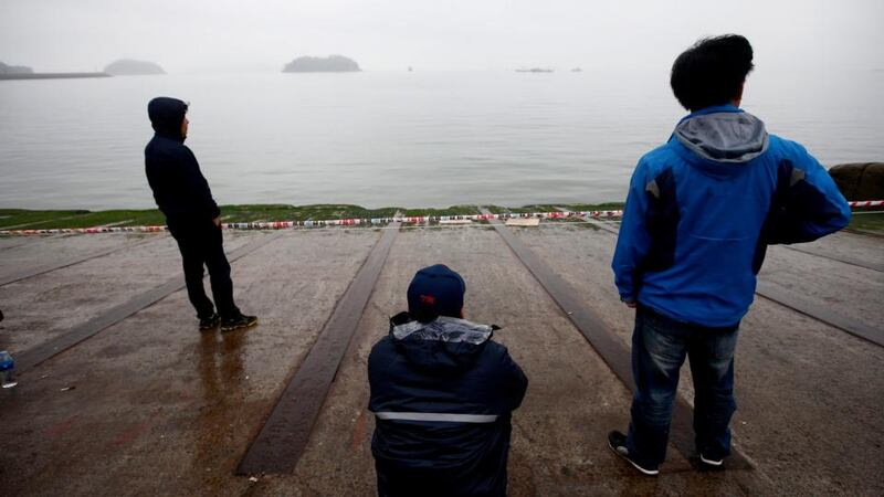 Anxious family members of missing passengers on the sunken ferry Sewol wait for news on their relatives at Jindo-port on Jindo Island. Photograph: Jeon Heon-Kyun