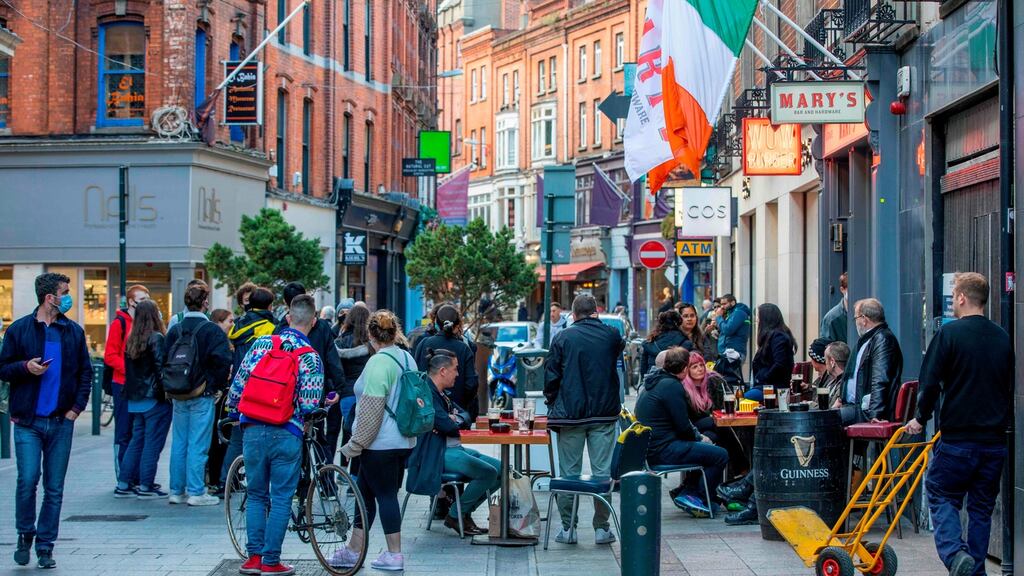 People drink at outside tables on a busy Grafton Street in Dublin on October 21st, as Ireland prepares to enter a second national lockdown to stem the spread of the virus that causes Covid-19. Photograph: Paul Faith/AFP via Getty Images
