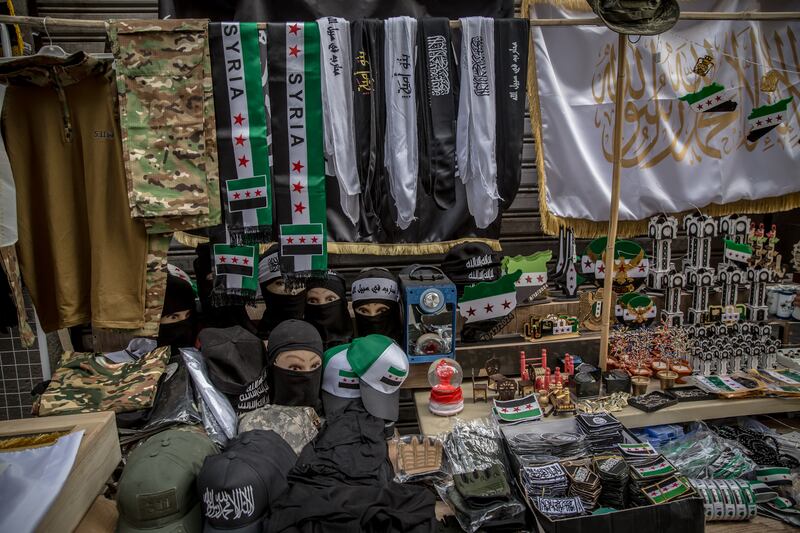 Goods branded with the Syrian revolutionary flag and the Islamic declaration of faith for sale in central Homs. Photograph: Sally Hayden