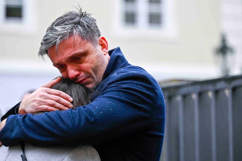 Mourners comfort each other outside the headquarters of Charles University. Photograph: AP/Denes Erdos