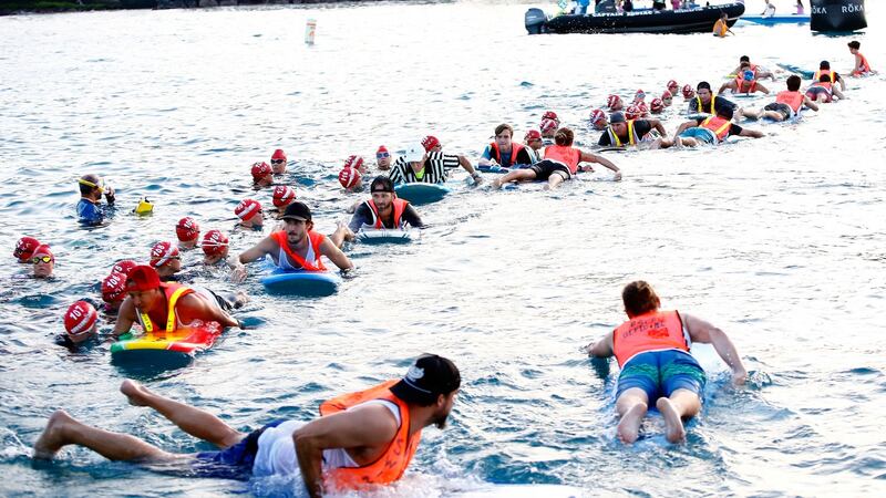 Surfers hold the line before the women’s pro start at the Ironman World Championship last month.