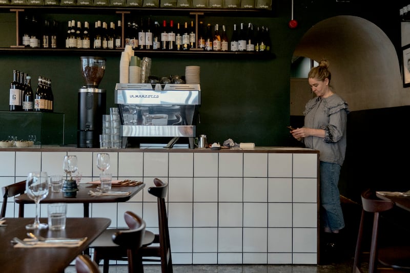 Coffee cups stacked beside the machine tell you that the space works just as well for breakfast and brunch