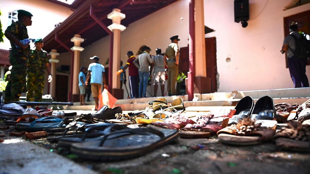 Shoes of victims are kept as evidence as security personnel inspect the interior of St Sebastian’s Church, a day after the church was hit in series of bomb blasts targeting churches and luxury hotels in Sri Lanka. Photograph: Jewel Samad/AFP/Getty Images