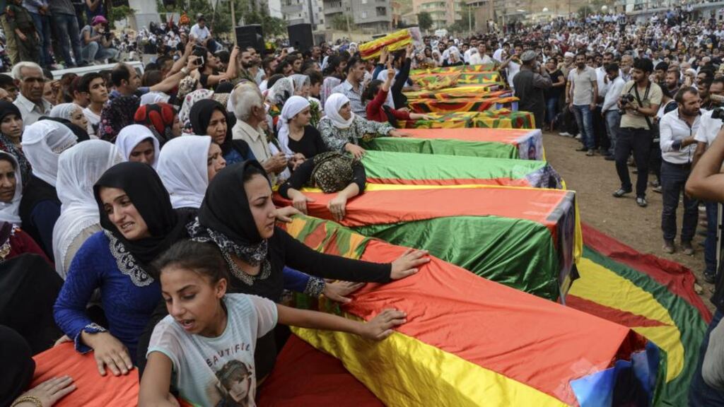Coffins are draped in the Kurdish flag during the funerals of people killed during clashes between Turkish forces and PKK militants, in Cizre, Turkey. Photograph: Llyas Akengin/AFP/Getty Images