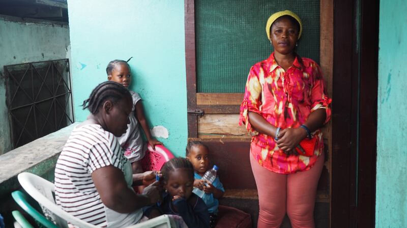 George Weah’s sister, Yvonne Weah, outside the home where they grew up in Clara Town. Photograph: Lorraine Mallinder