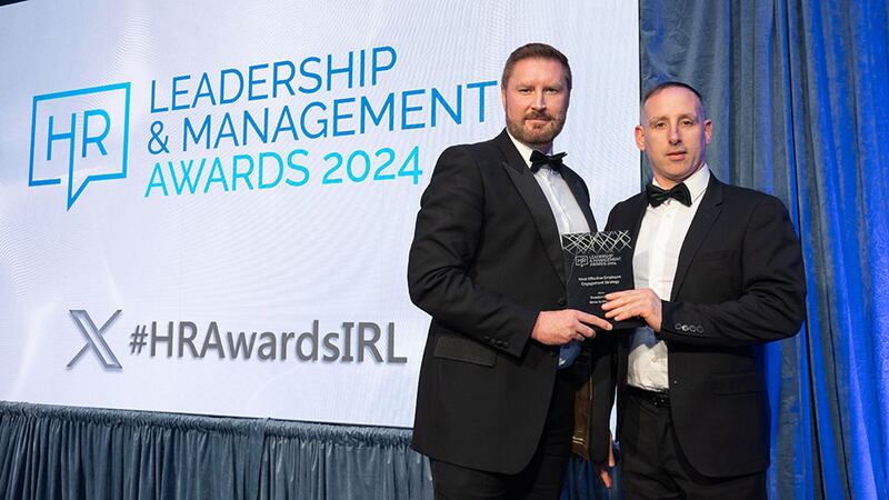Gareth McGrane, awards judge, presents the most effective employee engagement strategy award to Garrett Ghee, Breedon Group