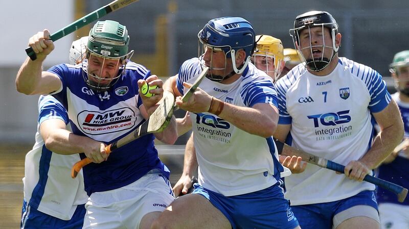 Waterford’s Shane Bennett and Ian Kenny tackle Willie Dunphy of Laois during their qualifier clash at Nowlan Park. Photograph: Lorraine O’Sullivan/Inpho