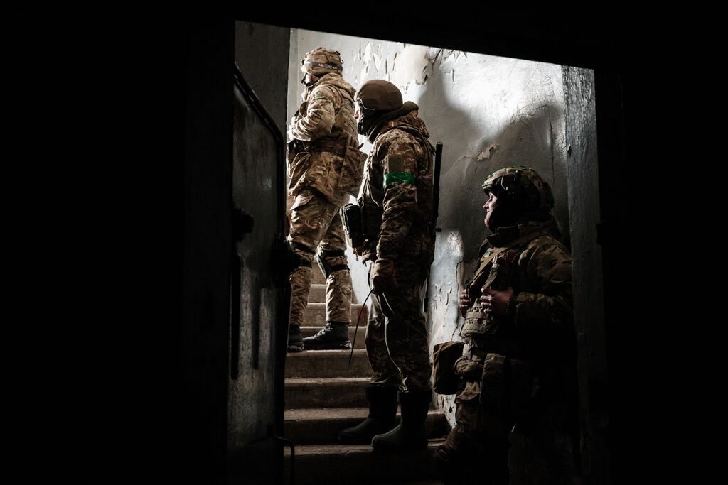 Ukrainian soldiers wait to move to a mortar position at the entrance of a shelter in Bakhmut. Photograph: YASUYOSHI CHIBA/AFP via Getty Images