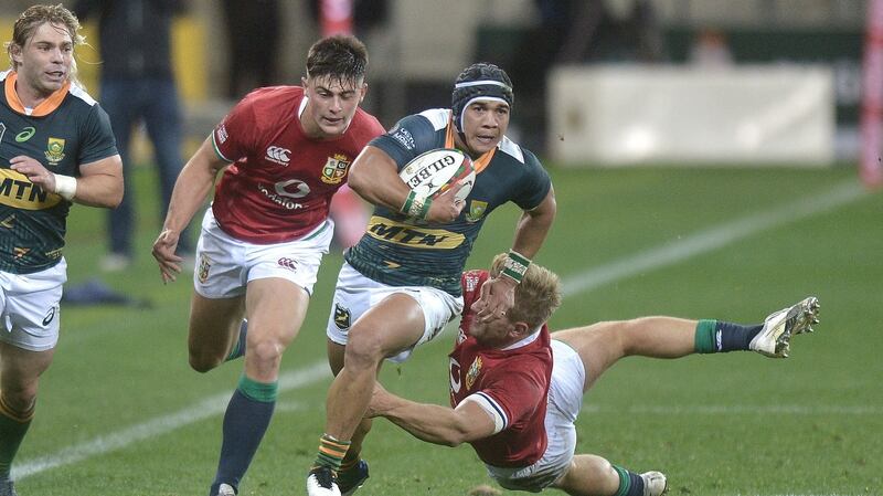 Cheslin Kolbe of the South African A team skips past Chris Harris Lions. Photograph: Luigi Bennett/EPA