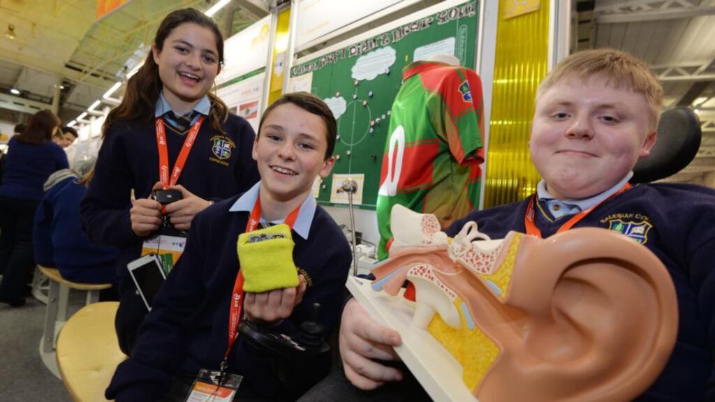 Zoe Mangan, Padraic Hartigan and Ross Fitzgerald from Salesian Secondary College, Limerick with their project The Silent Whistle a wearable device to help sports players with hearing impairments acknowledge the whistle of a referee during a match or training at the BT Young Scientist & Technology Exhibition 2015. Photograph: Alan Betson