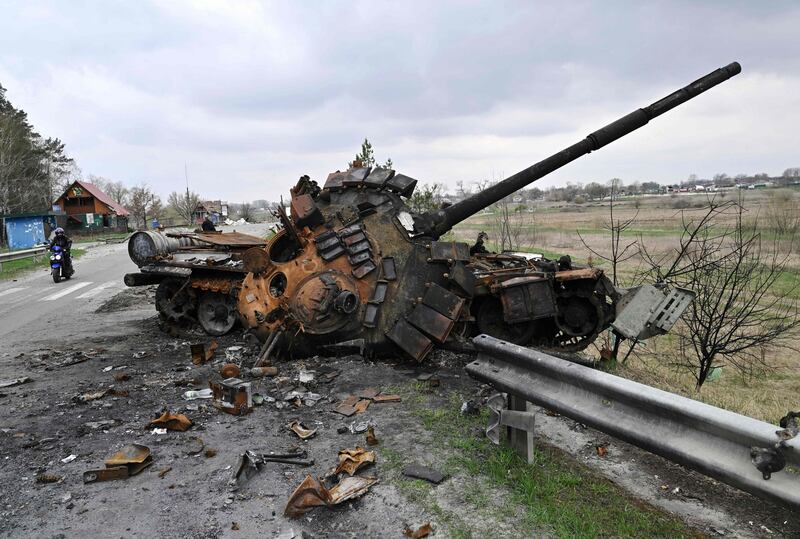 A man rides a motorbike past a destroyed Russian tank on a road in the village of Rusaniv, in the Kyiv region on April 16th. Photograph: Genya Savilov/AFP via Getty