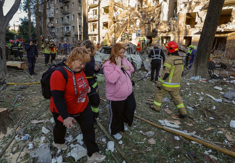 Residents at the site of a rocket strike on a five-storey residential building in Kyiv. Photograph: Sergey Dolzhenko/ EPA