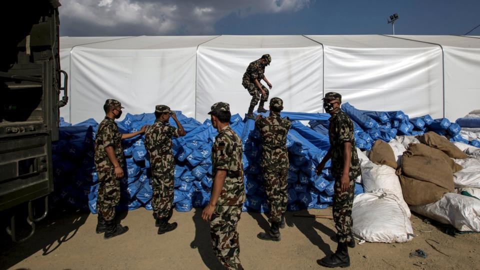 Aid effort: Nepalese soldiers load emergency tents to provide shelter for victims of the earthquake. Photograph: Danish Siddiqui/Reuters