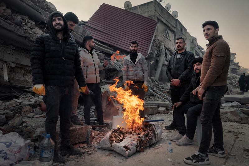 Men keep warm by a bonfire in the old quarter of Antakya, Hatay province, Turkey, three days after the earthquake. File photograph: Emily Garthwaite/New York Times