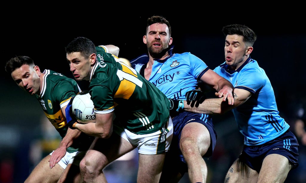 Kerry’s Micheal Burns and Paul Geaney tussles for possession with Seán MacMahon and David Byrne of Dublin during the NFL Division 1 clash in Tralee on Saturday. Photograph: Ryan Byrne/Inpho