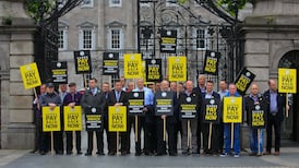 Dáil briefly suspended in row over pay restoration