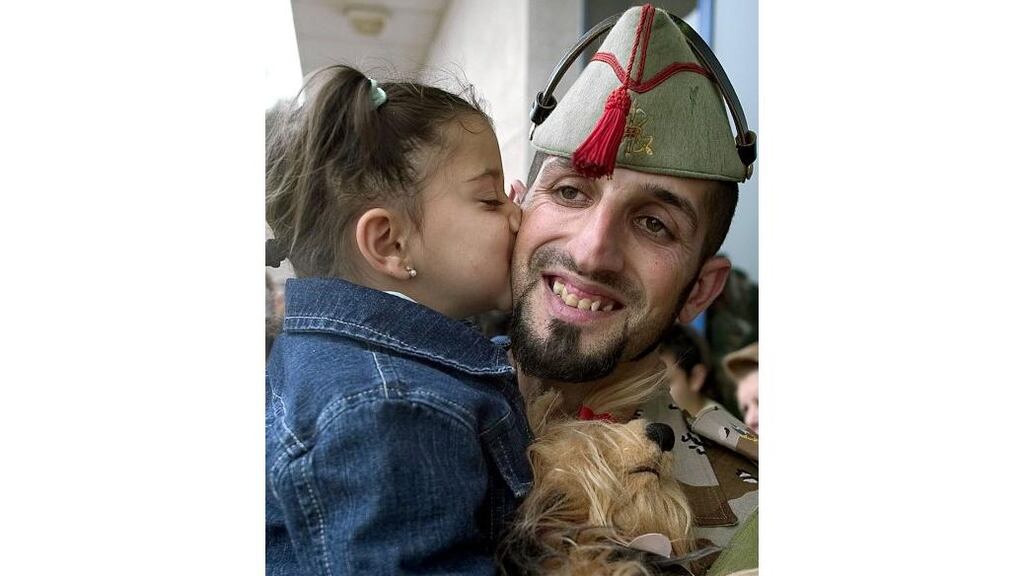 A Spanish soldier gets a kiss from his daughter before leaving the airport of Almeria, Spain yesterday. Photograph: Jose Manuel Vidal/AP