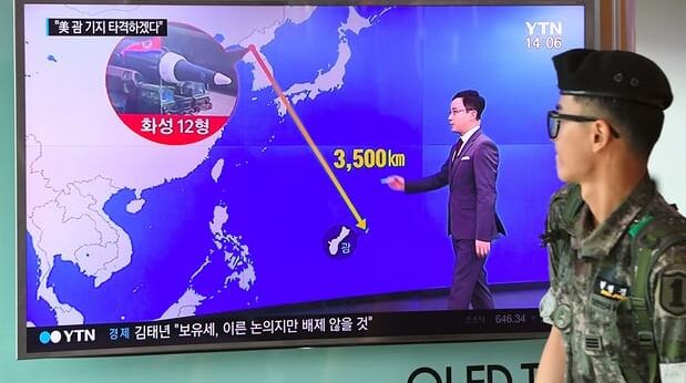 News bulletin shows the distance between Guam and North Korea at a railway station in Seoul. Photograph: Jung Yeon-Je/AFP/Getty Images