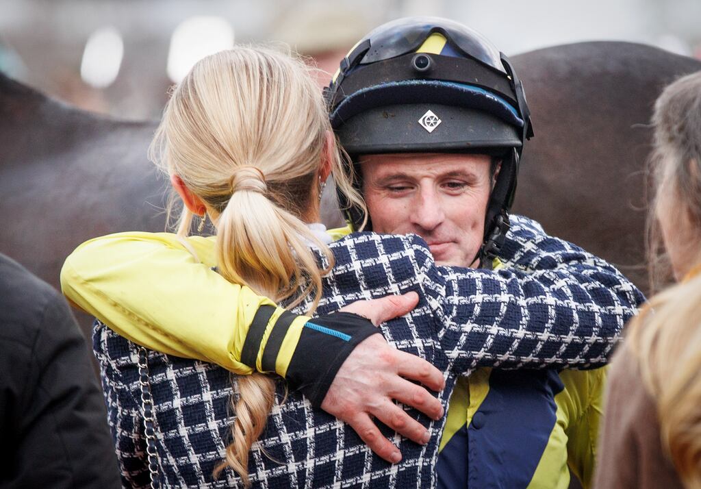 Jockey Sean Flanagan hugs Charlotte Giles, the girlfriend of the late Michael O’Sullivan, after winning on Marine Nationale in the Queen Mother Champion Chase. Photograph: Tom Maher/Inpho