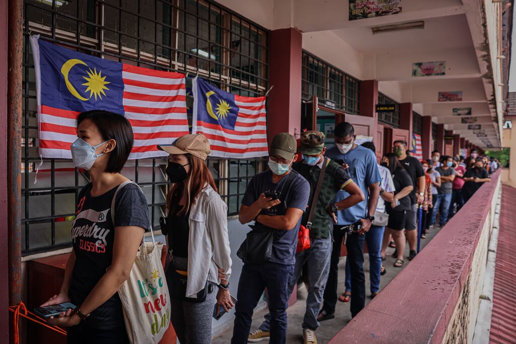 Voters wait in line at a polling station during the 15th general election in Kuala Lumpur, Malaysia. Photograph: Annice Lyn/Getty Images