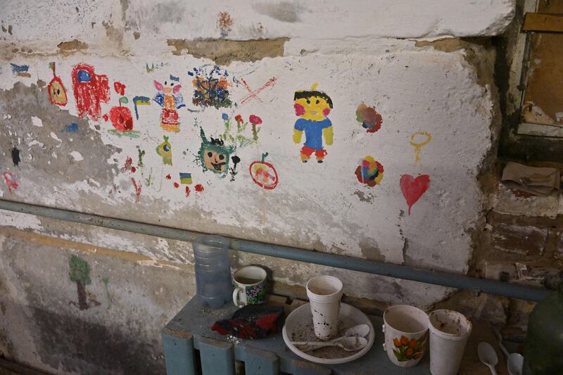 Children's drawings in the basement of the school in Yahidne. Photograph: Sergei Supinsky/AFP via Getty Images