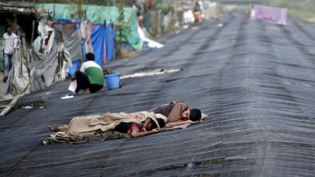 Men sleep on a temporary shade built over a drain next to a slum during a heatwave in New Delhi, India, May 28th, 2015. Photograph: Reuters/Anindito Mukherjee