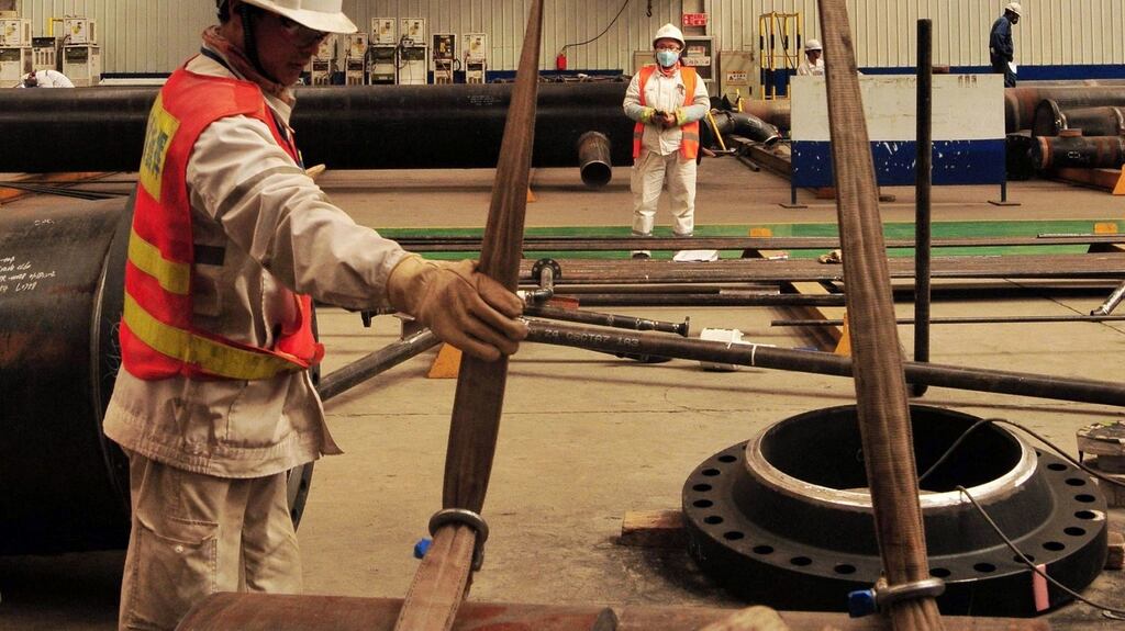 Chinese workers hoist assembly units at an offshore oil drilling platform in Qingdao, east China’s Shandong province. Chinese manufacturing activity expanded in March for the first time in nine months