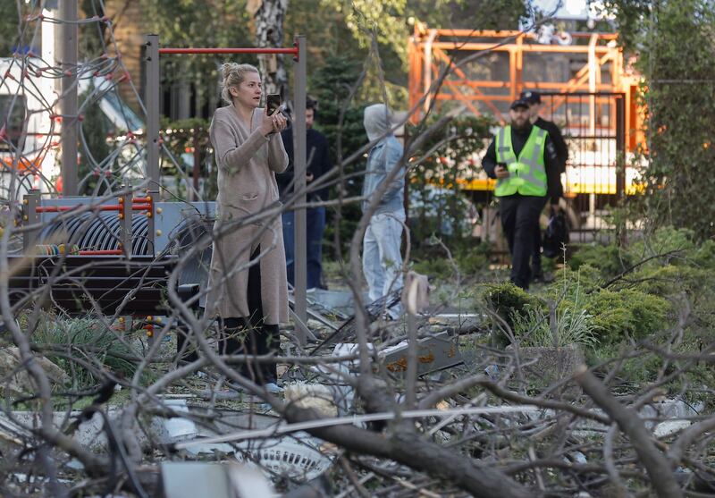 Emergency services and residents at the site of a rocket strike on a five-storey residential building in Kyiv. Photograph: Sergey Dolzhenko/EPA