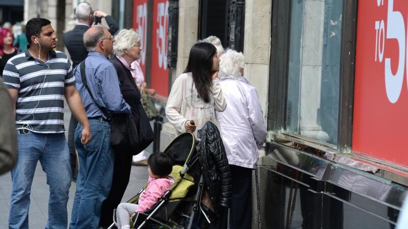 Passers-by reading the notice posted on the Clerys shopfront after the department store closed on Friday. Photograph: at Clerys, O’Connell Street, Dublin.Photograph: Dara Mac Dónaill/The Irish Times