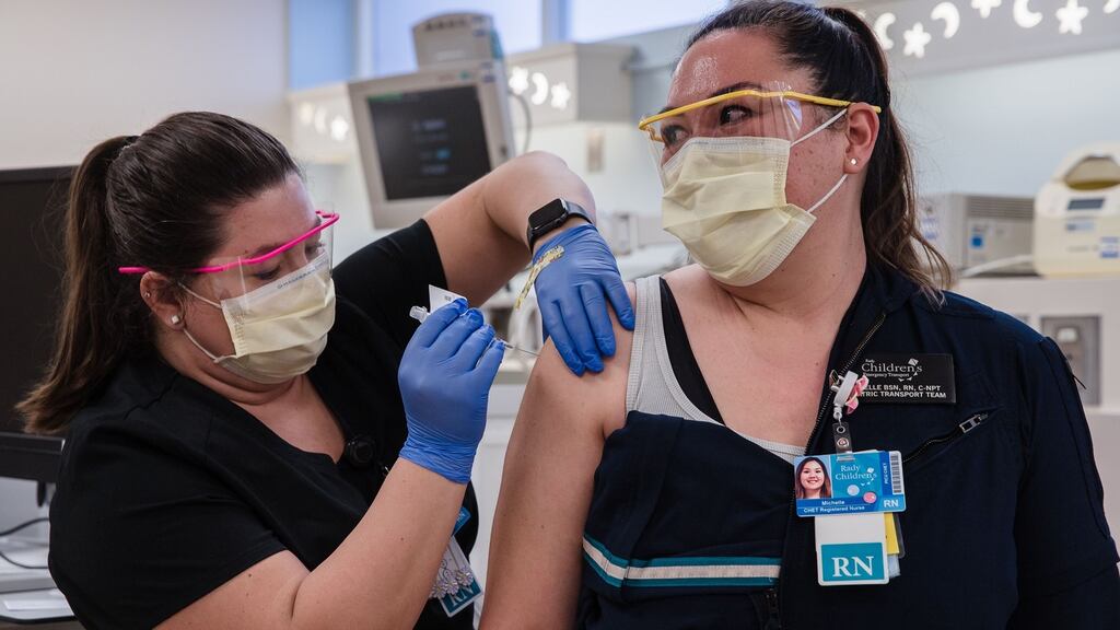 Rachel Marrs gives the Pfizer-BioNTech Covid-19 vaccine to Michelle Gaano, a Nurse at Rady Children’s Hospital in San Diego, California on December 15th. Photograph: Ariana Drehsler/AFP/Getty Images.