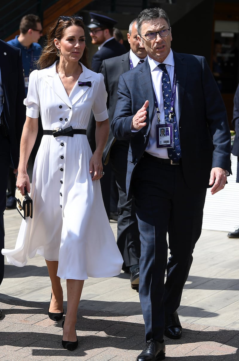 Catherine, Duchess of Cambridge at Wimbledon in a white midi dress by Suzannah, with an Alexander McQueen bag. Photograph: Mike Hewitt/Getty Images