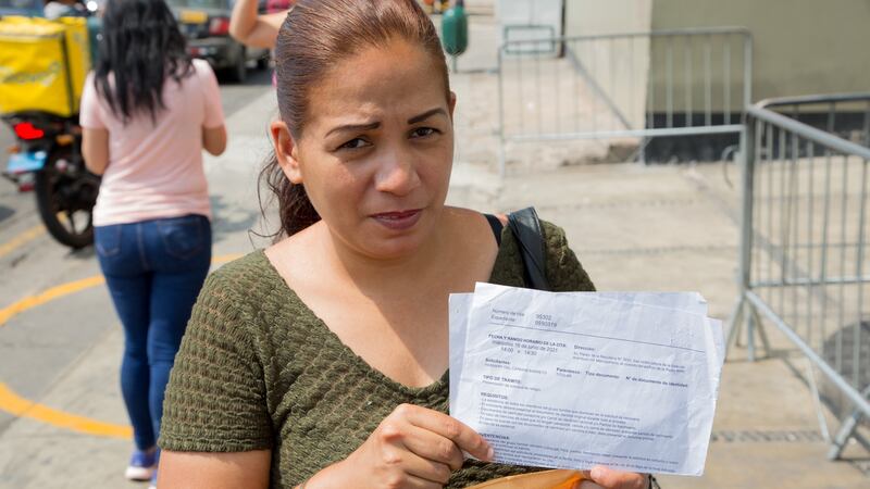 Barreto Yasmerys (39) displays the letter informing her that her asylum claim will not be heard until June 2021, outside the asylum claims office in Lima, Peru. Photograph: Paul Musiol