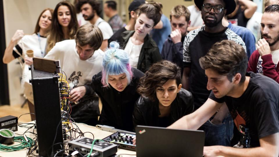 DJ James Holden and RBMA delegates at work in the studio