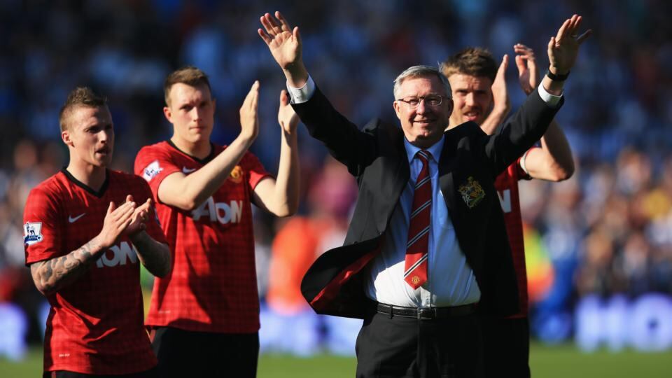 Manchester United manager Alex Ferguson is applauded by players after his 1,500th and final match in charge of the club . Photograph: Richard Heathcote/Getty Images