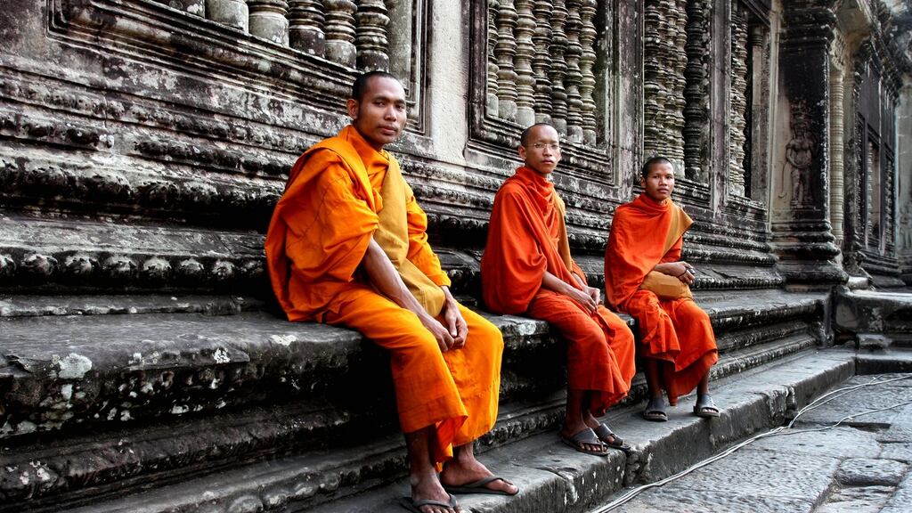 Monks make their way to Angkor Wat, five kilometres north of Siem Reap. It is hidden among forests. The temples took their place on the UNESCO World Heritage List in 1992