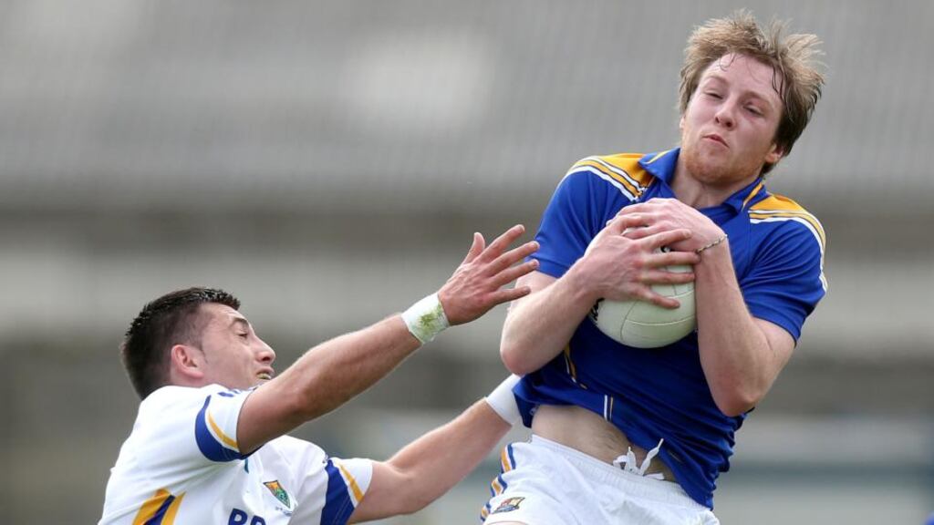 Wicklow’s Darragh Hayden fields the ball ahead of Pádraig McCormack of Longford at O’Byrne Park. Photograph: Ryan Byrne/Inpho