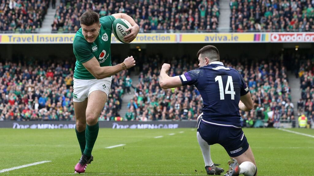 Jacob Stockdale runs past Blair Kinghorn to score his second  try against Scotland. Photograph:  Brian Lawless/PA Wire