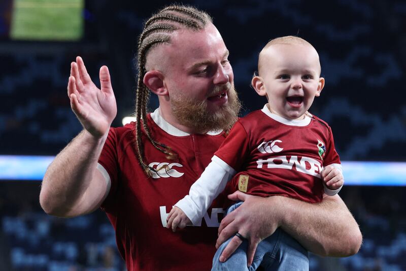 Finlay Bealham with his child after the British and Irish Lions' victory against Waratahs last Saturday. Photograph: David Gray/AFP via Getty Images